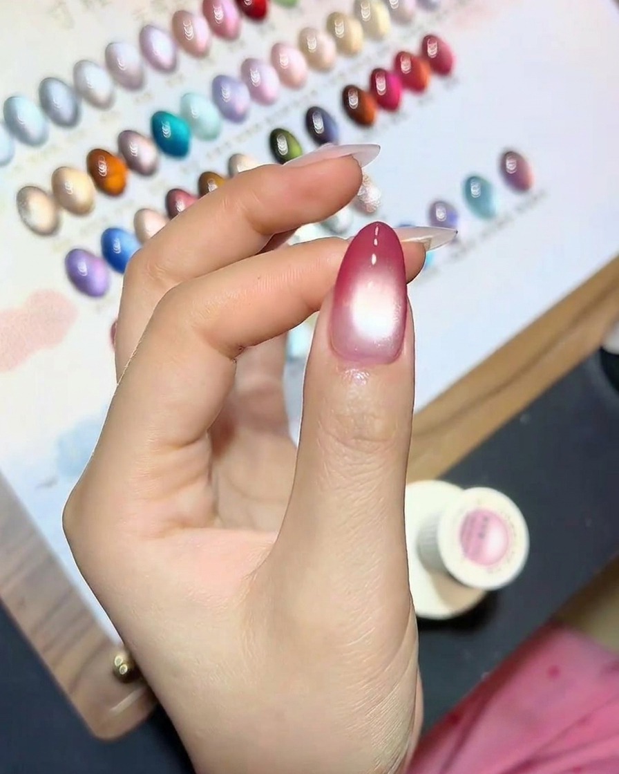 Un ongle avec leffet œil de chat en cours de catalysation sous une lampe UV.