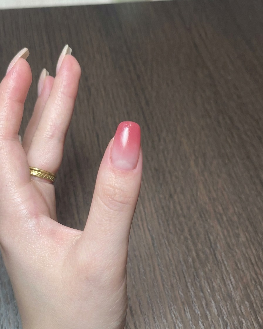 Une mini lampe portable catalysant le vernis gel sur un ongle.