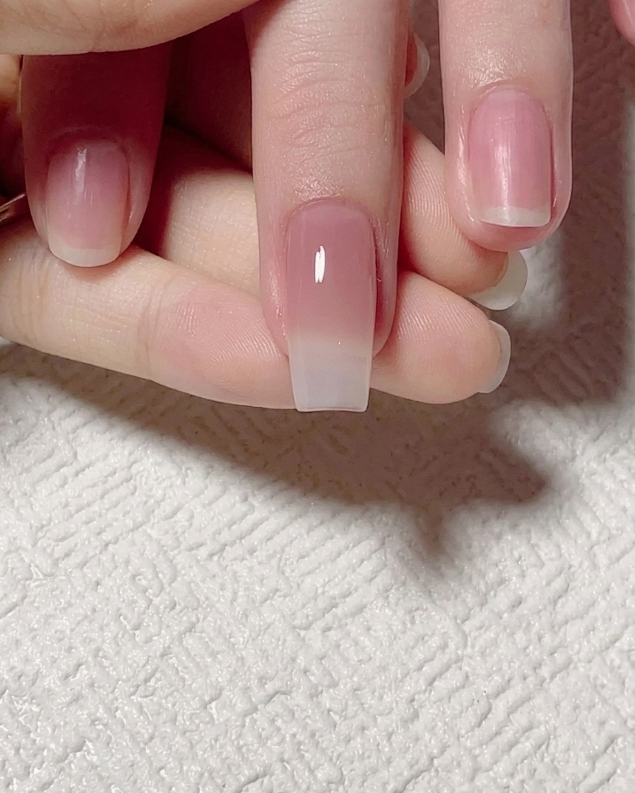 Un pinceau plat estompant le gel teinté jade vers le haut pour une transition douce.