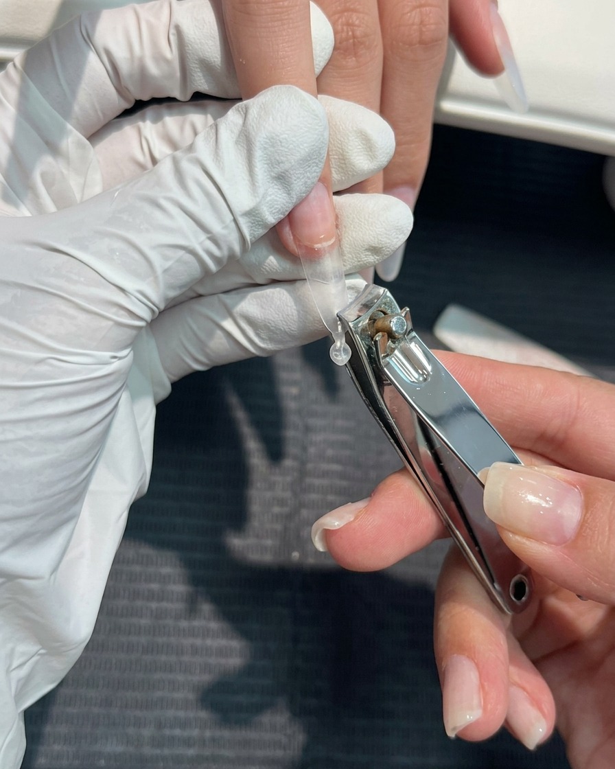 Gros plan dun coupe-ongle utilisé pour couper une capsule plastique à la longueur désirée.