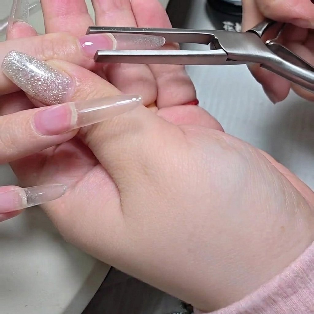 Un pinceau gel plat appliquant une seconde couche de gel pour renforcer la structure.