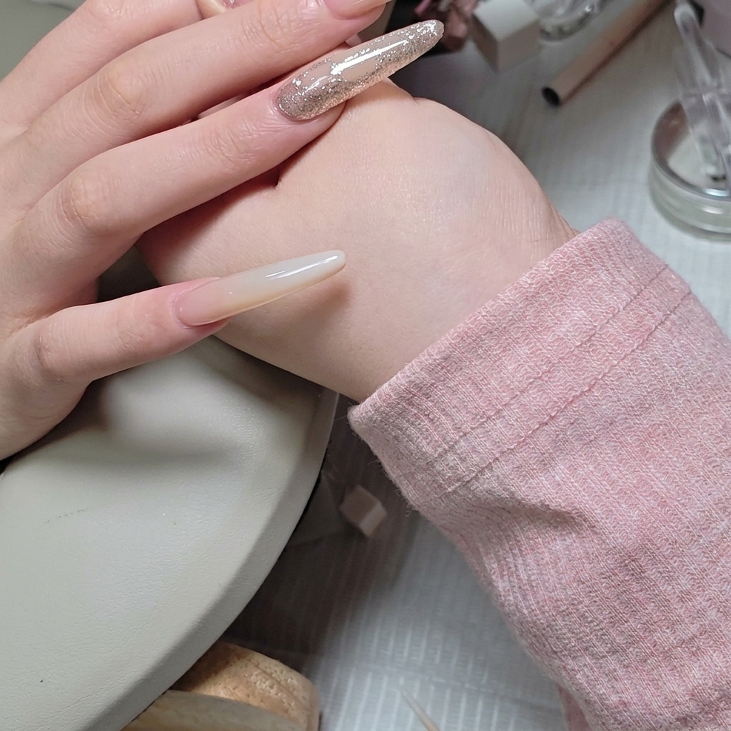 Un pinceau liner fin appliquant soigneusement du gel de construction autour des strass.