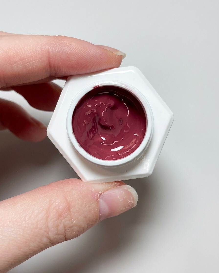 Un pinceau appliquant un top coat transparent et brillant sur le design dongle cat eye terminé.