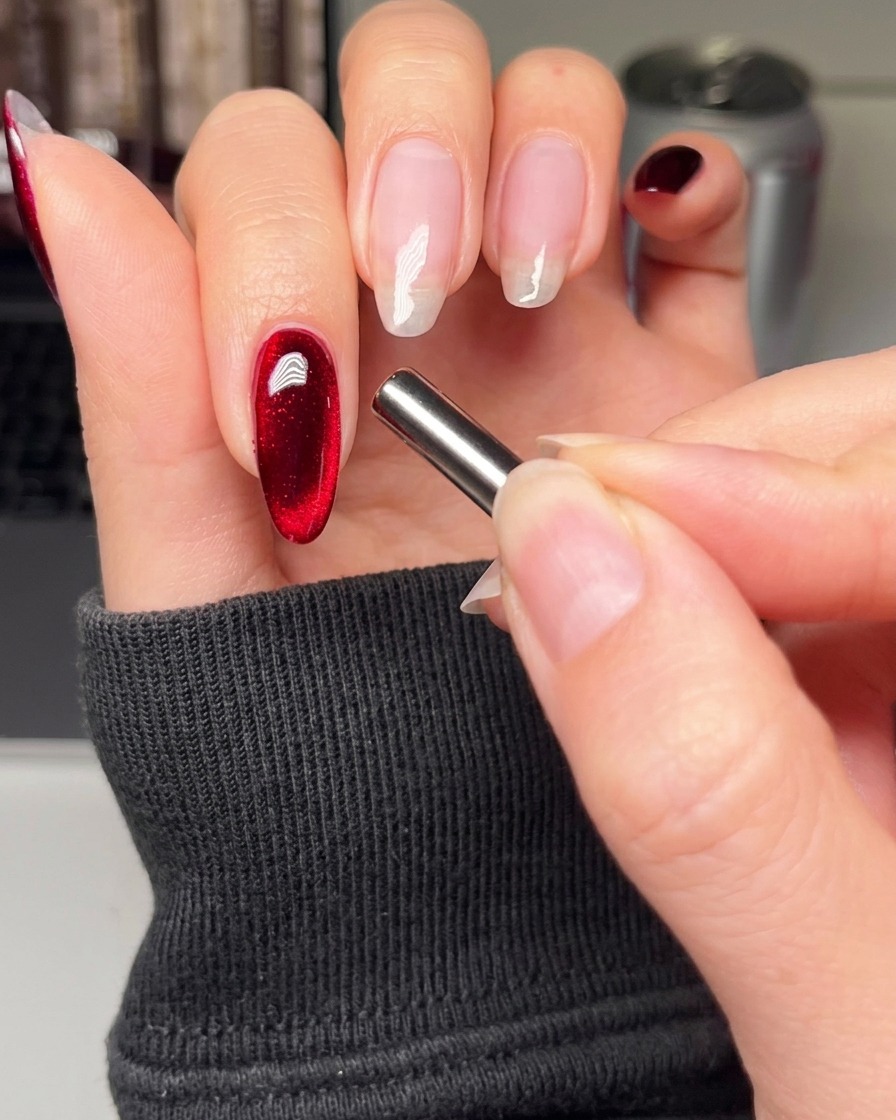 Un pinceau appliquant une couche lisse de vernis gel noir sur lindex.