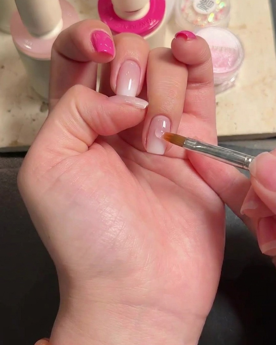 Gros plan montrant une goutte de colle à ongles appliquée sur lannulaire.