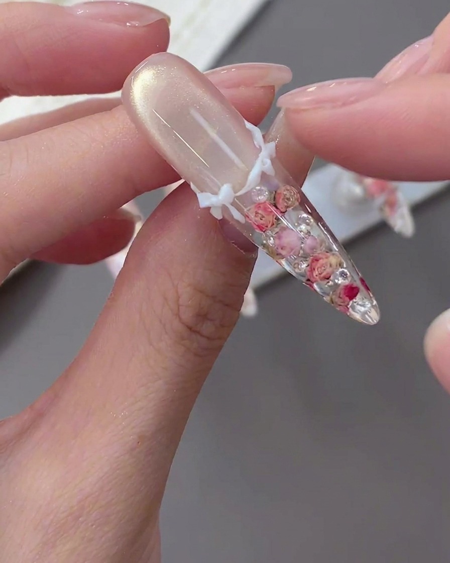 Gros plan dun doigt posant un nœud 3D blanc sur une capsule décorée.