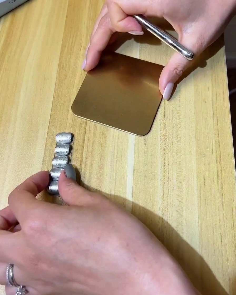 Un pinceau liner fin dessinant un petit nuage avec du gel transparent sur un ongle mat.