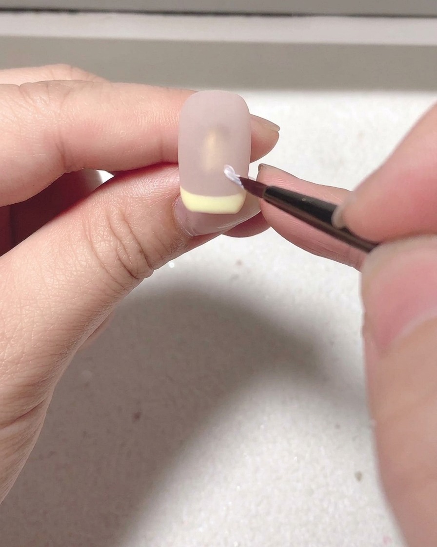 Longle avec le top coat mat en train de catalyser sous la lampe UV/LED.