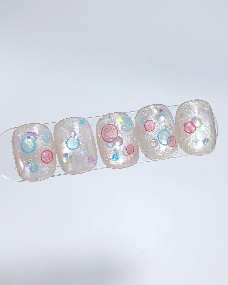 Un pinceau appliquant une couche de gel nude sur une capsule, tapotant pour une répartition uniforme.