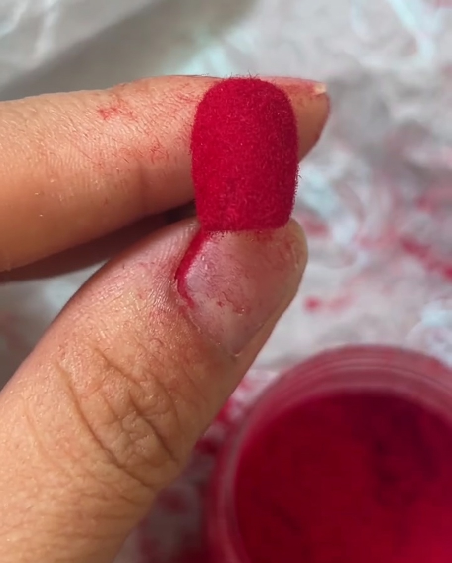 Vue macro dun ongle avec une texture velours rouge éclatante.