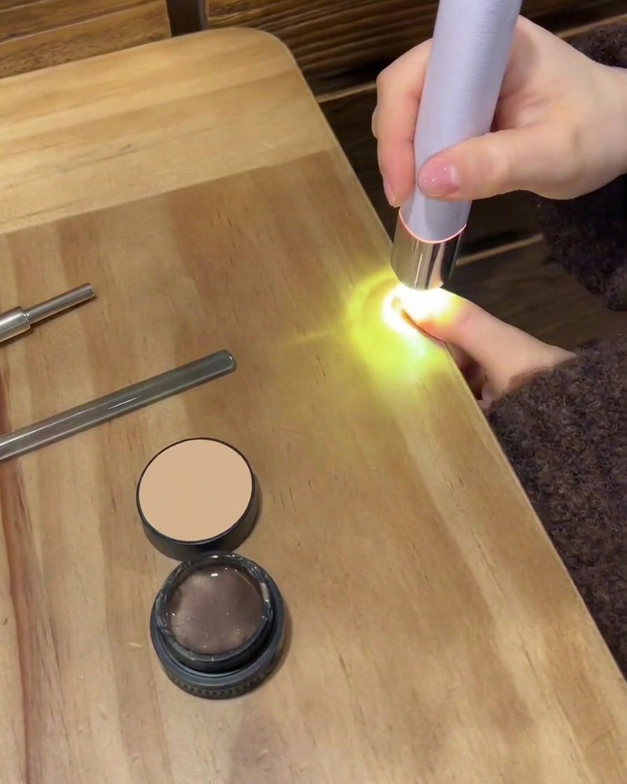 Un petit disque de coton essuyant la surface dun ongle pour éliminer les résidus collants.