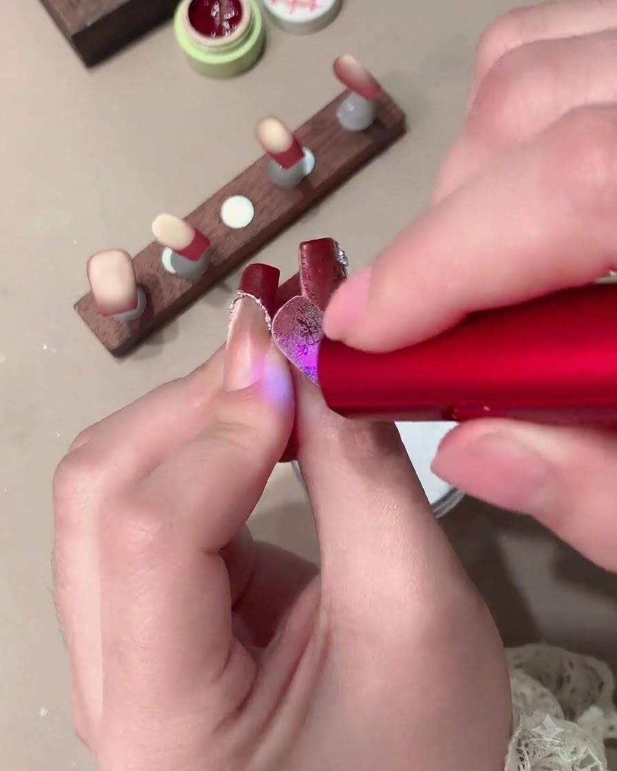 Un pinceau doux éliminant lexcès de poudre de cristal blanche dun ongle décoré.