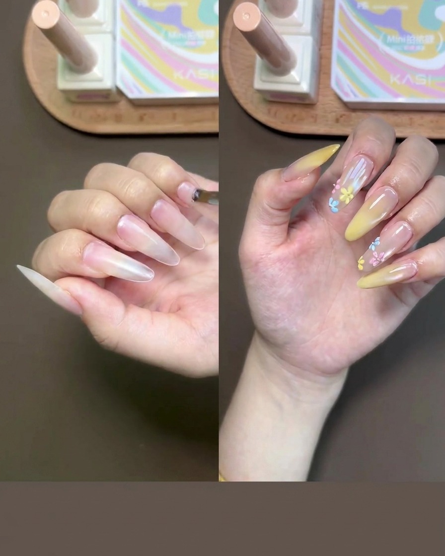 Gros plan dune main recevant lapplication dun gel de base nude sur les ongles à laide dun petit pinceau.