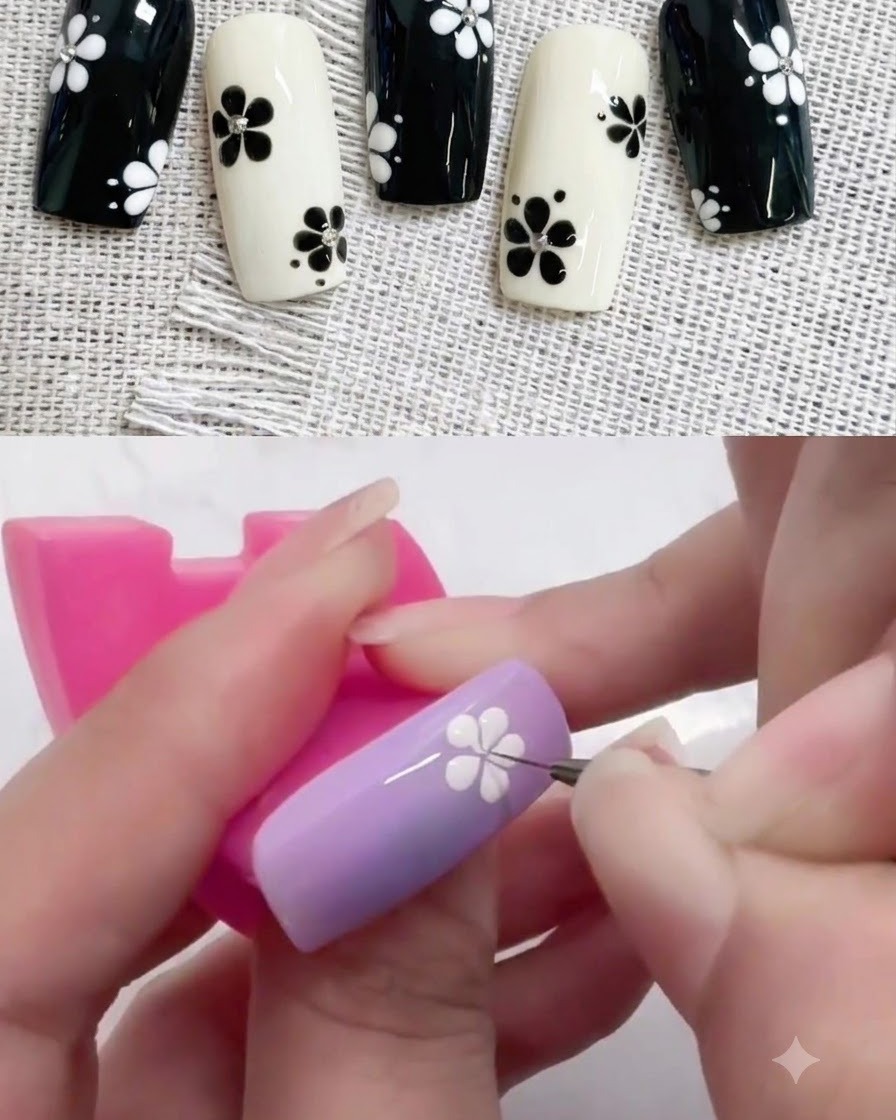 Un petit dotting tool plaçant un point central noir au cœur dun design de fleur blanche sur un ongle violet.