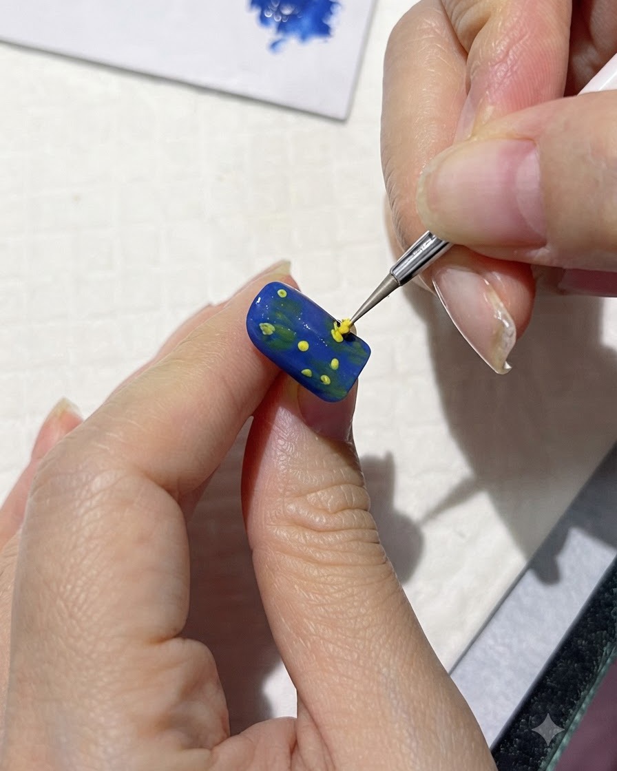 Un pinceau fin peignant des formes de pétales jaunes lâches autour des points centraux sur un ongle bleu.