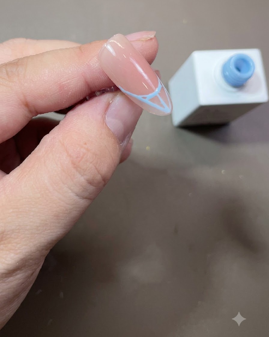 Un contour de French tip bleue rempli solidement avec du vernis gel bleu sur un ongle en amande.