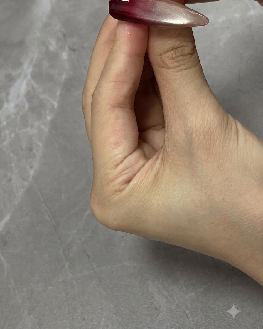 Un doigt tapotant doucement la surface du gel frais pour diffuser les lignes dures et créer une transition en dégradé ombré.