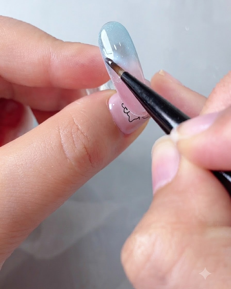 Un pinceau fin diffusant les bords du gel nuage blanc sur un fond dongle en dégradé à laide de blooming gel.