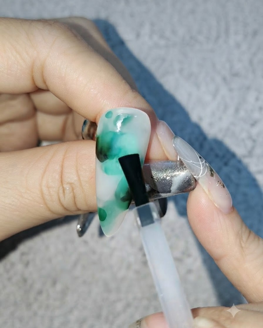 Un pinceau fin mélangeant de petits points de couleur noire dans le motif blooming vert.