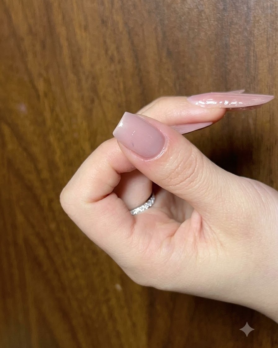 Gros plan des contours en gel noir achevés sur un nail art papillon.