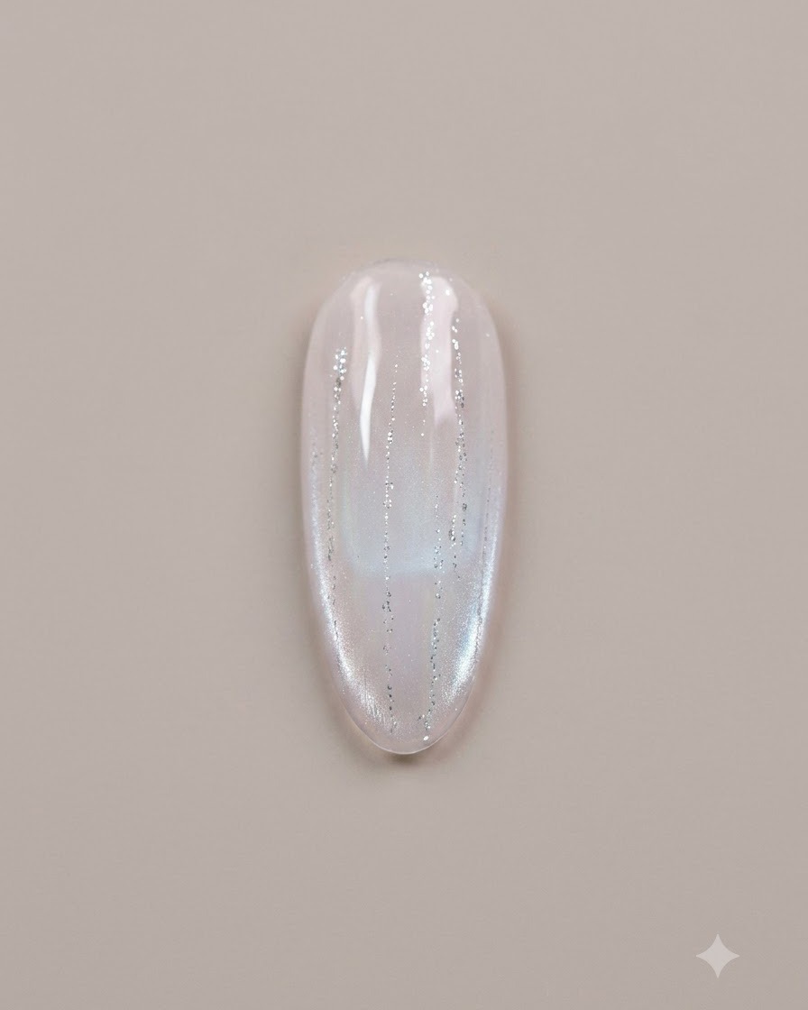 Une vue aérienne à plat dun ongle en gel avec des paillettes détoiles éparpillées incrustées dans une surface en gel non catalysée.
