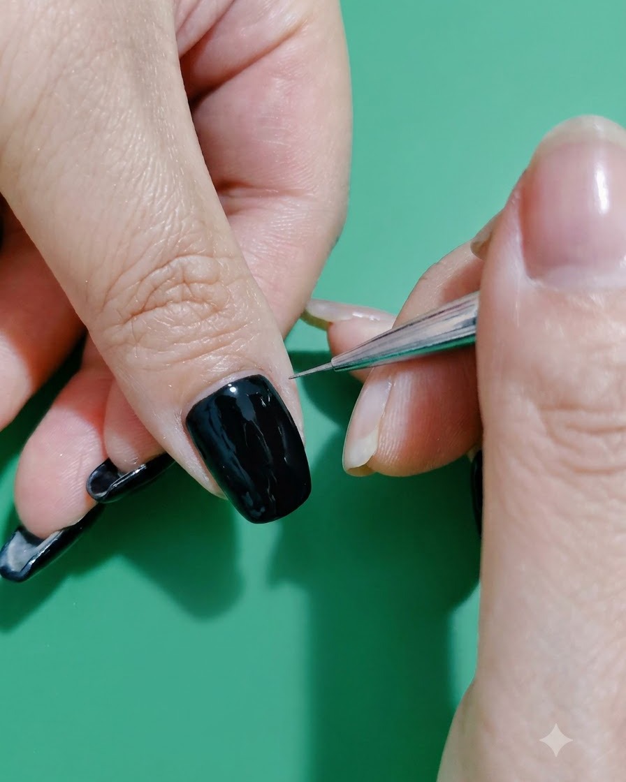 Un pinceau liner fin dessinant une ligne de paillettes délicate le long de la cuticule dun ongle noir.