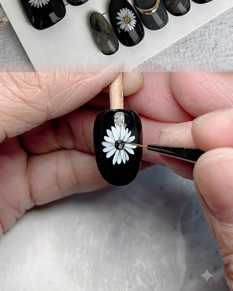 Un pinceau fin appliquant du gel noir au centre de la marguerite peinte.