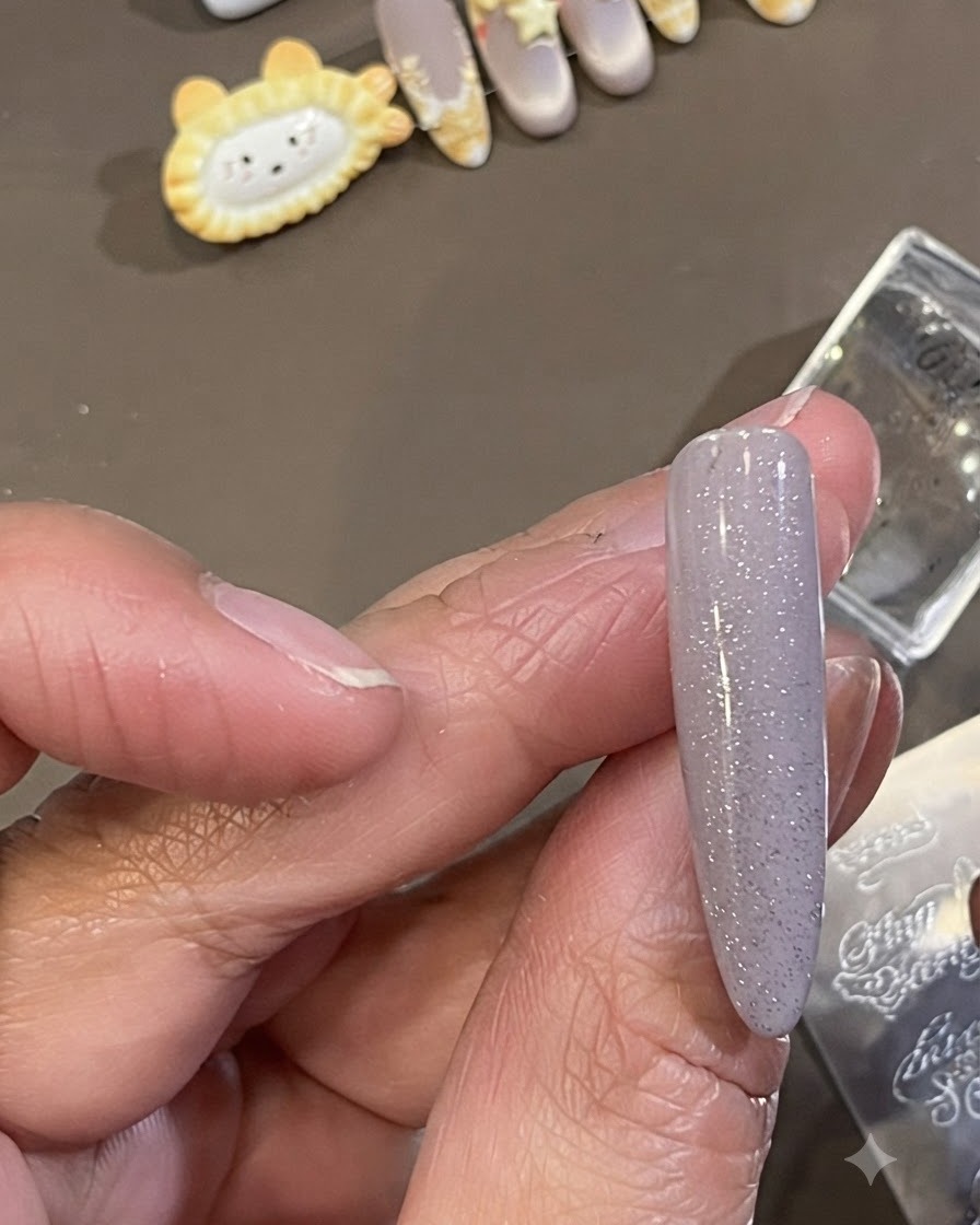 Un petit pinceau de nettoyage essuyant lexcédent de vernis destampage sombre de la peau entourant le côté dun ongle manucuré.