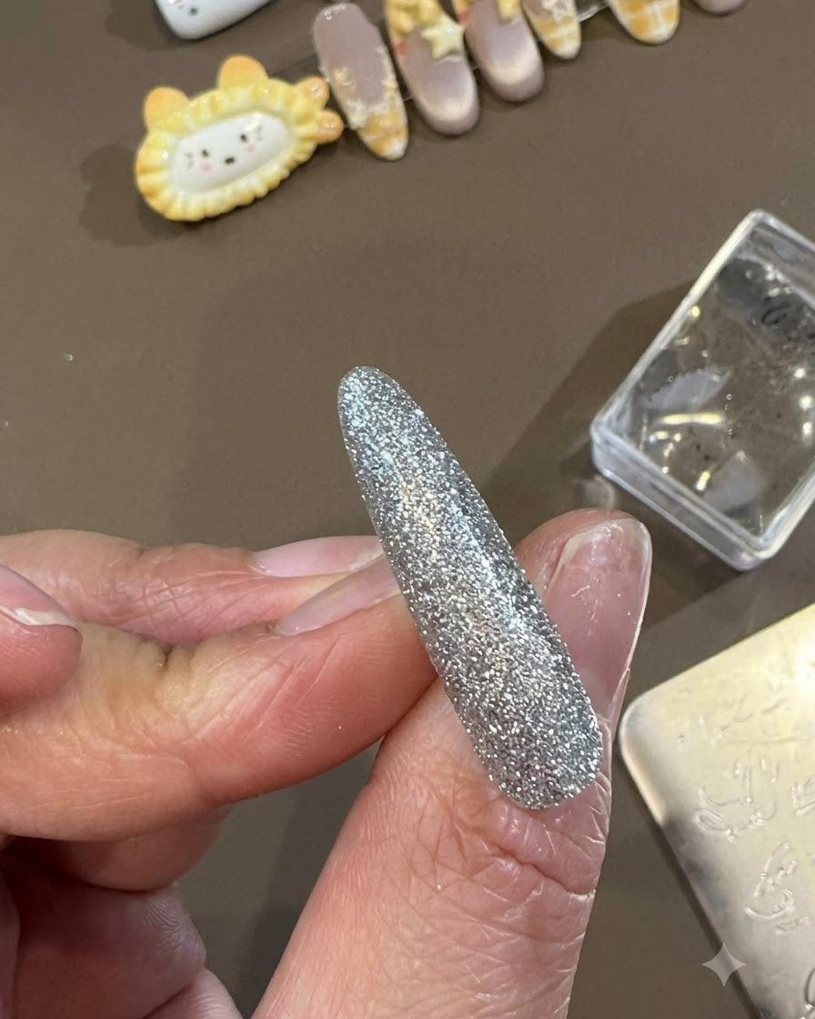Un pinceau de top coat en gel glissant une couche lisse et brillante de top coat sur un design dongle décoratif terminé.