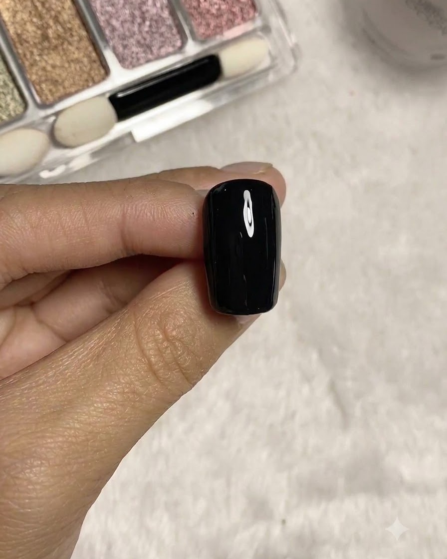 Un pinceau liner long dessinant de fines lignes dimensionnelles sur la surface dongle texturée noire.